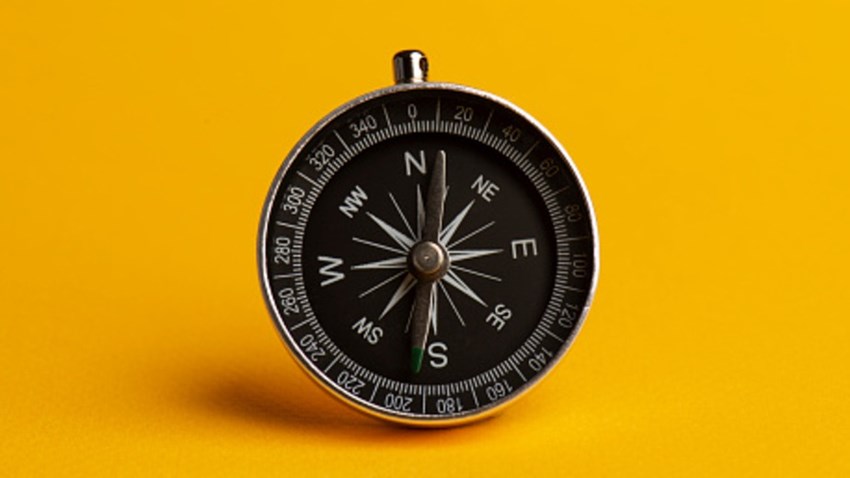 Compass on the yellow background.