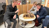 Tobbe Trollkarl spelar schack med en pappa och son