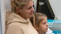 Mamma och dotter lutar sig mot varandra i musikstudion